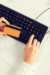 Image showing businesswoman with laptop using credit card