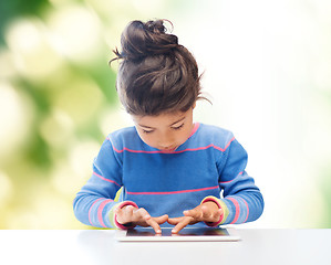 Image showing little girl with tablet pc over green background