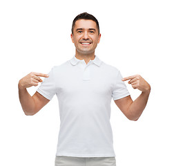 Image showing smiling man in t-shirt pointing fingers on himself