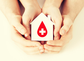 Image showing hands holding house with donor sign