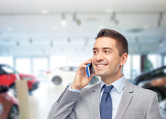 Image showing happy businessman calling on smartphone
