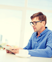 Image showing man working with tablet pc at home