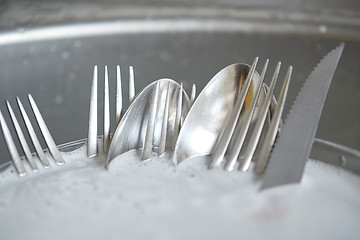 Image showing close up of dirty dishes washing in kitchen sink