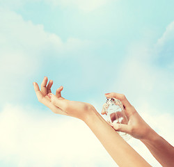 Image showing woman hands spraying perfume