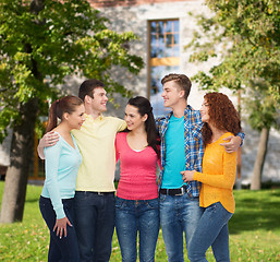 Image showing group of smiling teenagers over campus background