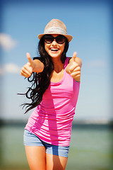 Image showing girl showing thumbs up on the beach