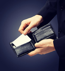 Image showing man in suit holding credit card