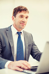 Image showing businessman with laptop in office