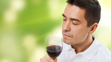 Image showing happy man drinking red wine from glass