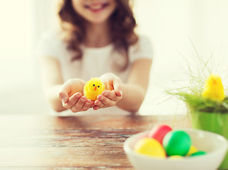 Image showing close up of girl holding yellow chiken toy