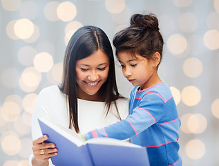 Image showing happy mother and daughter reading book