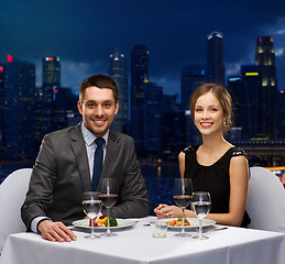 Image showing smiling couple eating main course at restaurant