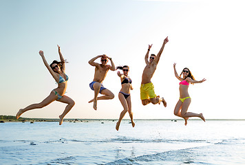 Image showing smiling friends in sunglasses on summer beach