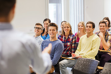 Image showing group of students and teacher with notebook