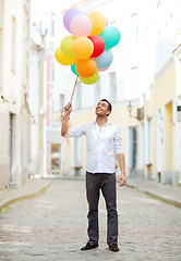 Image showing man with colorful balloons in the city