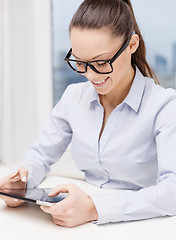 Image showing smiling businesswoman in eyeglasses with tablet pc