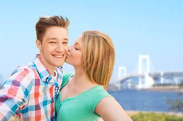 Image showing couple kissing and taking selfie over bridge