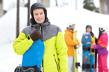 Image showing happy friends in helmets with snowboards