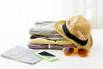 Image showing close up of summer clothes and travel map on table