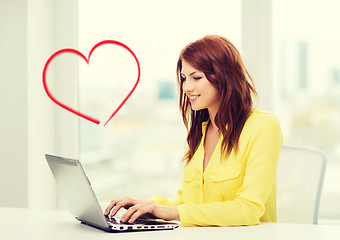 Image showing smiling student with laptop computer at school