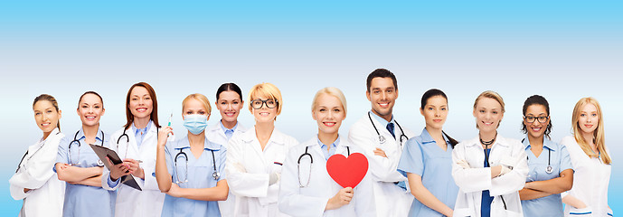 Image showing smiling doctors and nurses with red heart