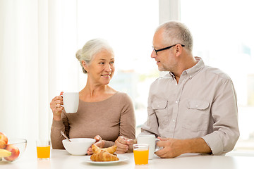 Image showing happy senior couple having breakfast at home