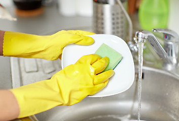 Image showing close up of woman hands washing dishes in kitchen