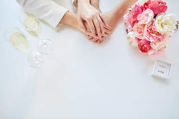 Image showing close up of lesbian couple hands and wedding rings