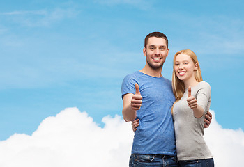 Image showing smiling couple showing thumbs up