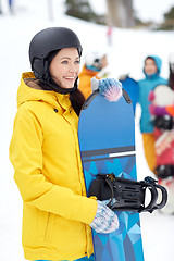 Image showing happy friends in helmets with snowboards