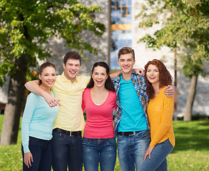 Image showing group of smiling teenagers over campus background