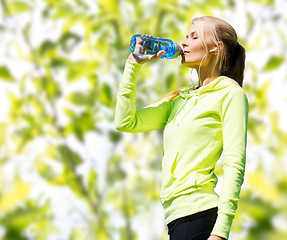 Image showing woman drinking water after doing sports outdoors