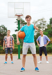 Image showing group of smiling teenagers playing basketball