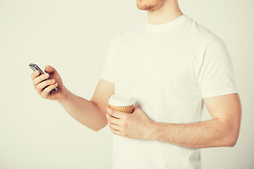 Image showing man with smartphone and coffee