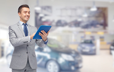 Image showing happy businessman in suit with tablet pc