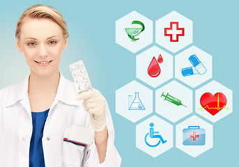 Image showing smiling female doctor showing pack of pills
