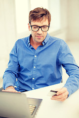 Image showing man with laptop and credit card at home