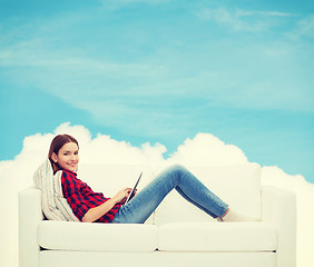 Image showing teenage girl sitting on sofa with tablet pc