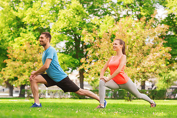 Image showing smiling couple stretching outdoors