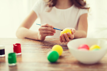 Image showing close up of girl coloring eggs for easter