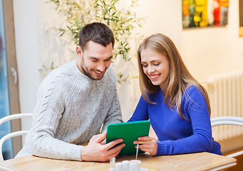 Image showing happy couple with tablet pc at cafe