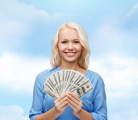 Image showing smiling young woman with us dollar money