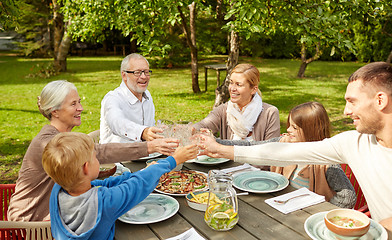 Image showing happy family having dinner in summer garden