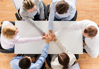 Image showing close up of business team with hands on top