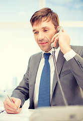 Image showing businessman with phone and documents