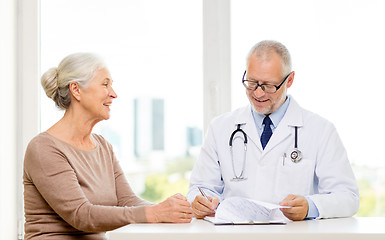 Image showing smiling senior woman and doctor meeting