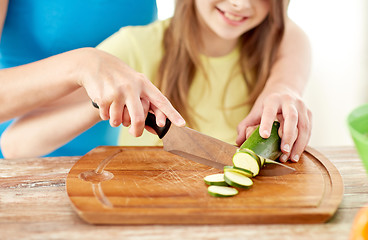 Image showing close up of happy family making dinner in kitchen