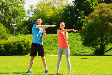 Image showing smiling couple stretching outdoors