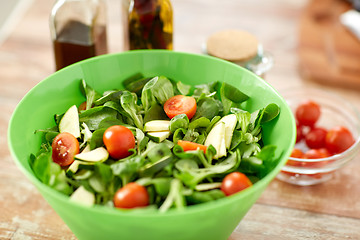 Image showing close up of salad bowl and spices on kitchen table