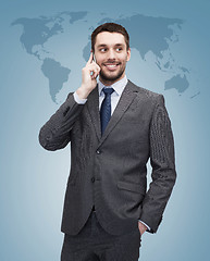 Image showing young smiling businessman with smartphone